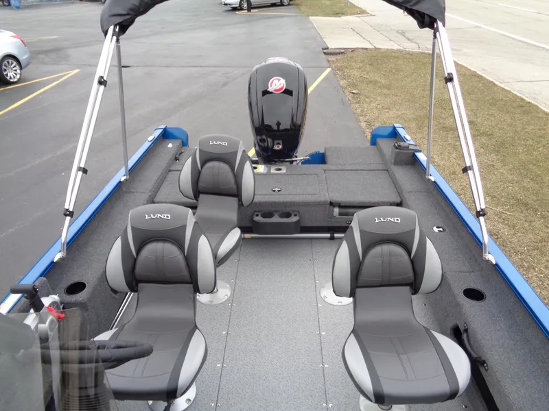 Slide: The Image of 2024 Lund 1775 Adventure SS boat interior with four seats and motor. - 9