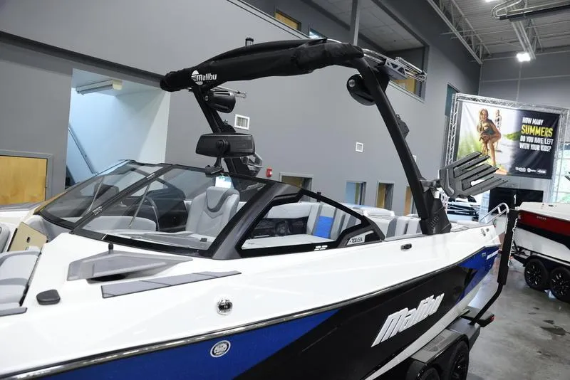 Slide: The Image of 2024 Malibu 23 LSV boat in showroom, featuring sleek design and modern amenities. - 10