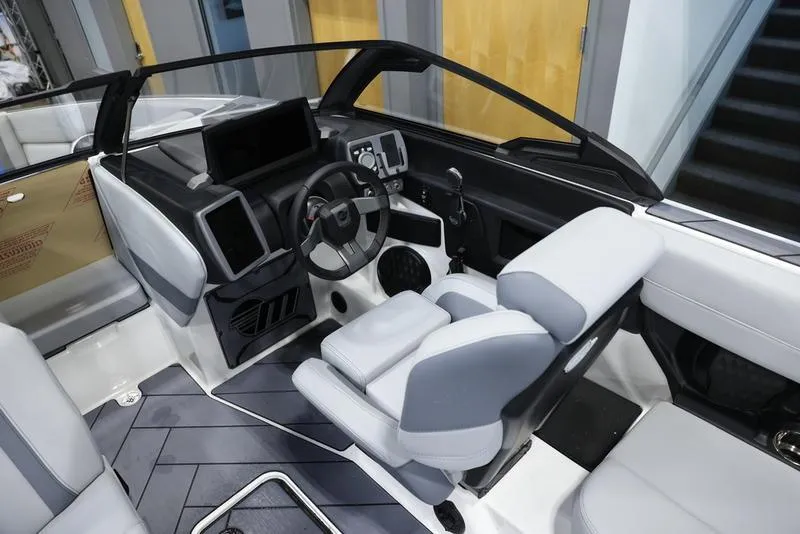 Slide: The Image of 2024 Malibu 23 LSV boat interior with modern dashboard and comfortable seating. - 13