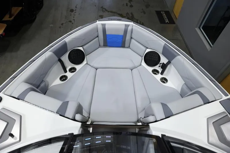 Slide: The Image of 2024 Malibu 23 LSV boat interior with gray and blue seating. - 15