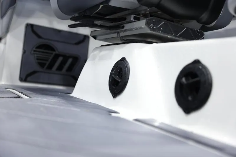 Slide: The Image of 2024 Malibu 23 LSV boat interior detail showing speaker and seating area. - 16