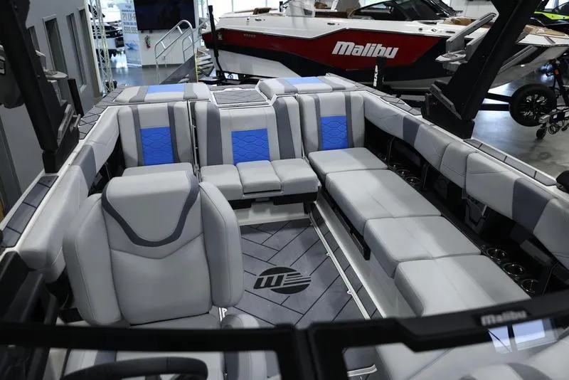 Slide: The Image of 2024 Malibu 23 LSV boat interior with gray and blue seating. - 19