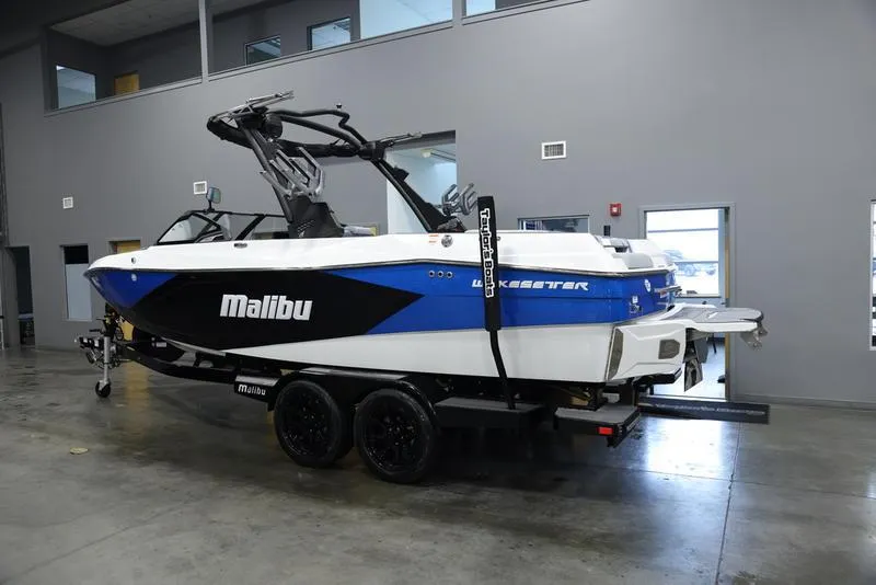 Slide: The Image of 2024 Malibu 23 LSV boat on trailer in indoor showroom. - 3