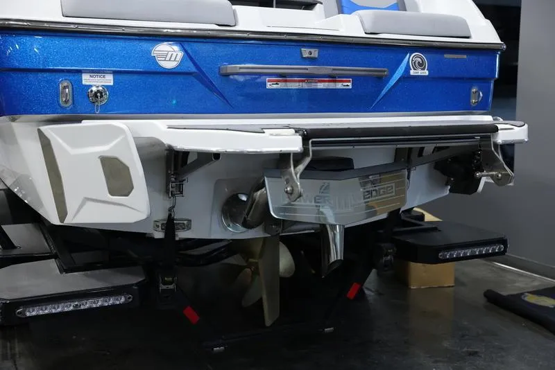 Slide: The Image of 2024 Malibu 23 LSV boat rear view, showcasing propeller and swim platform. - 5