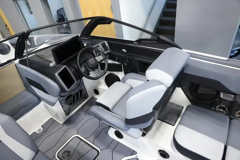 Slide: The Image of 2024 Malibu 23 MXZ boat interior with modern dashboard and seating. - 10