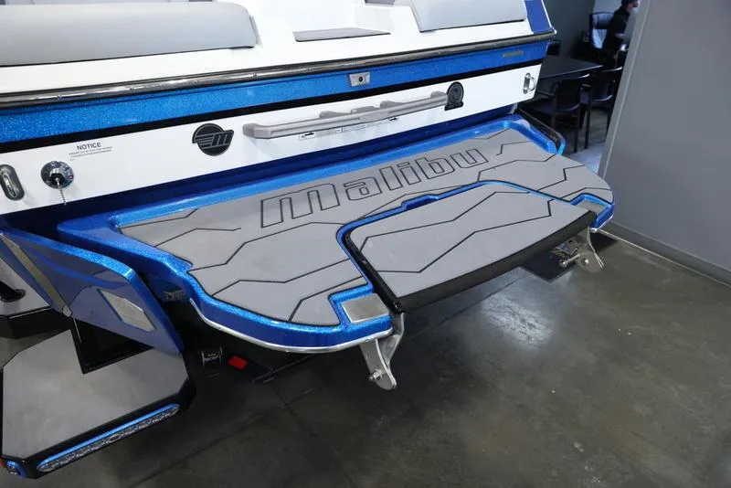 Slide: The Image of 2024 Malibu 23 MXZ boat rear view with swim platform. - 11
