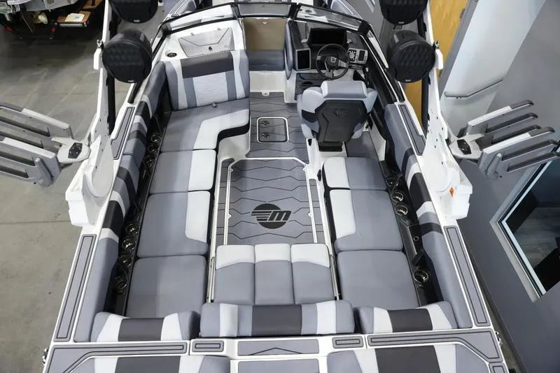 Slide: The Image of 2024 Malibu 23 MXZ boat interior with spacious seating and modern design. - 16