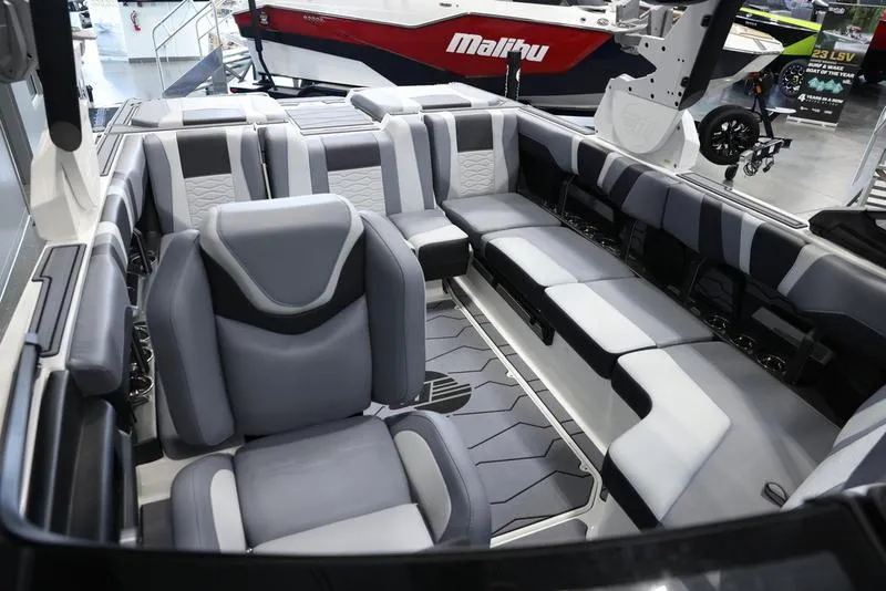 Slide: The Image of 2024 Malibu 23 MXZ boat interior with luxurious seating and modern design. - 19