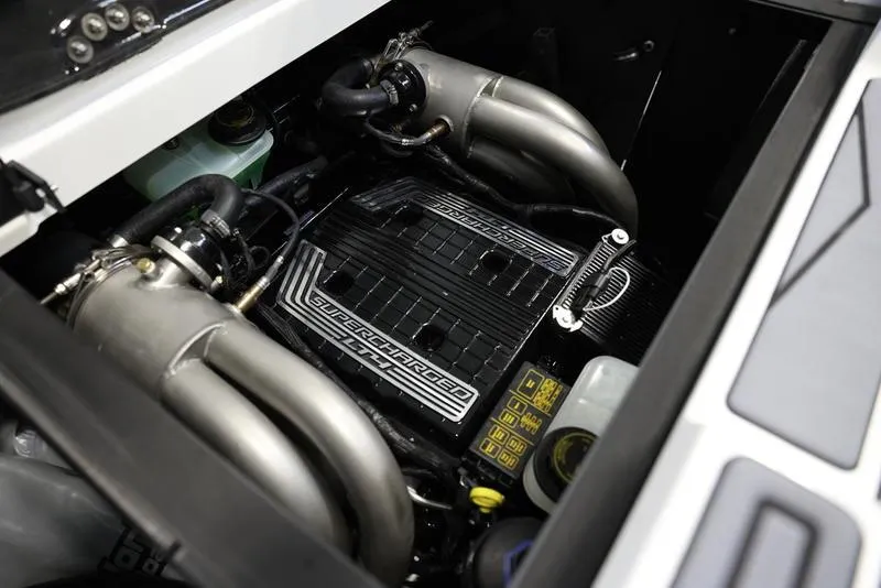 Slide: The Image of 2024 Malibu 23 MXZ engine compartment showcasing powerful supercharged engine. - 2