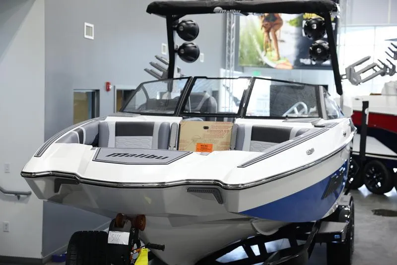 Slide: The Image of 2024 Malibu 23 MXZ boat on display in showroom. - 22
