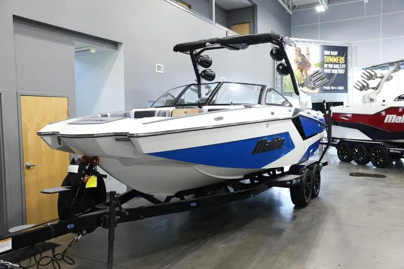Slide: The Image of 2024 Malibu 23 MXZ boat on display in showroom. - 24