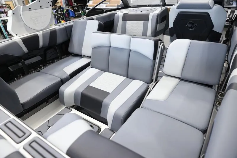 Slide: The Image of 2024 Malibu 23 MXZ boat interior with luxurious gray and white seating. - 5