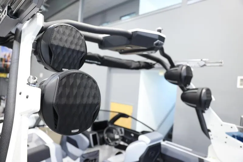 Slide: The Image of 2024 Malibu 23 MXZ boat with mounted speakers and modern interior. - 7