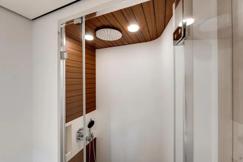 Slide: The Image of Modern shower in 2024 Azimut Fly 78 yacht with wood paneling and rainfall showerhead. - 16