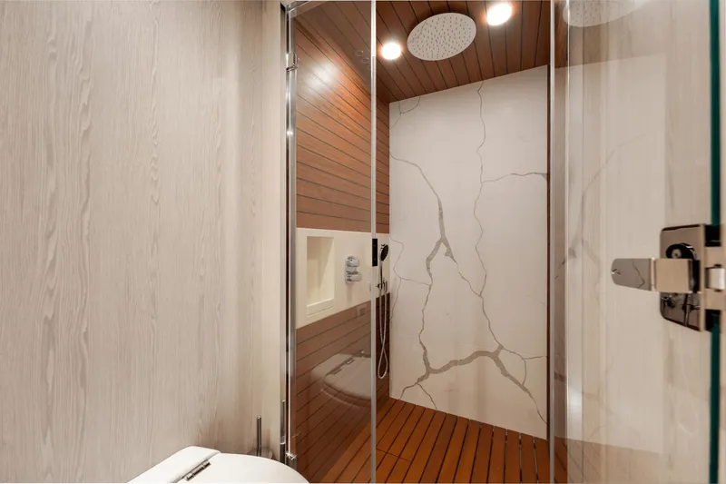 Slide: The Image of Modern shower area in 2024 Azimut Fly 78 yacht with wood and marble accents. - 32