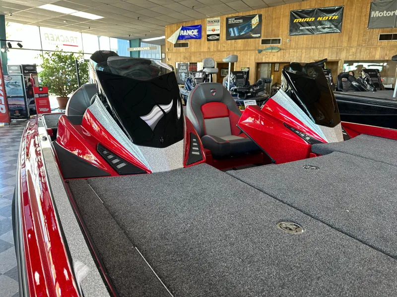 Slide: The Image of 2024 Triton 20XP Patriot boat interior with red and black seats in showroom. - 13