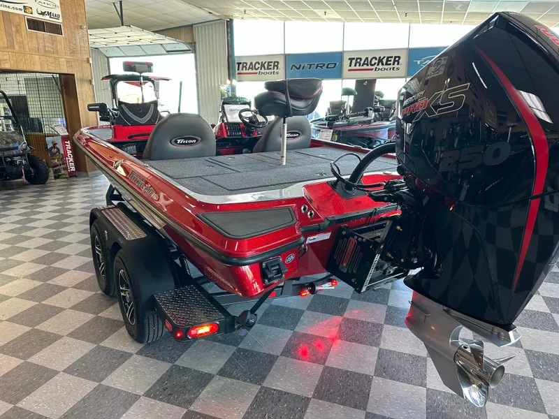 Slide: The Image of 2024 Triton 20XP Patriot bass boat in showroom, rear view with Mercury 250 engine. - 9