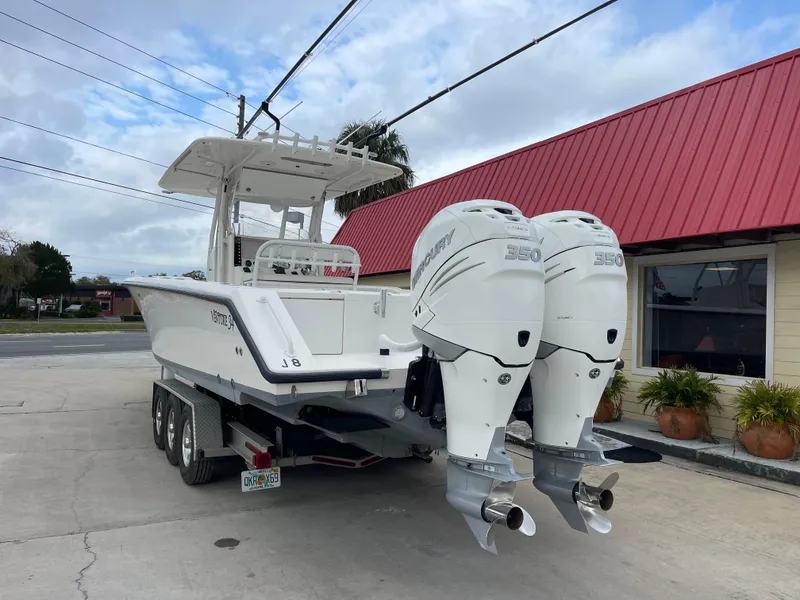 Slide: The Image of 1999 Venture 34 Center Console boat with twin 350 horsepower engines on trailer. - 4