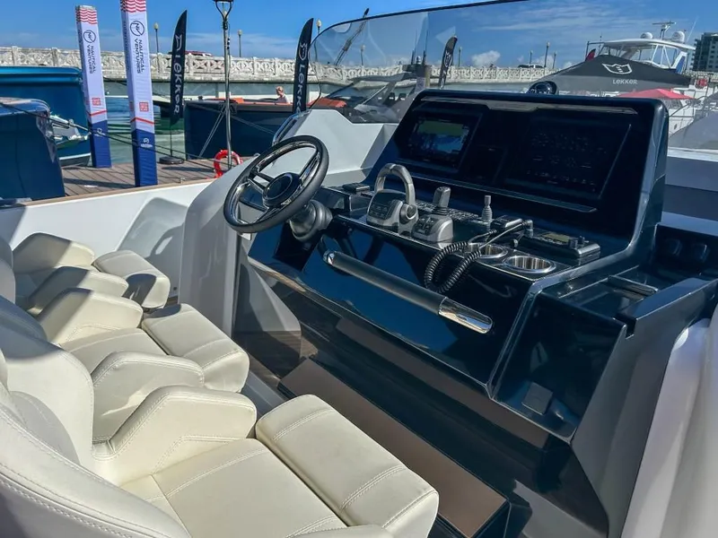 Slide: The Image of 2024 Solaris Power 40 Open yacht helm with modern controls and luxurious seating. - 6