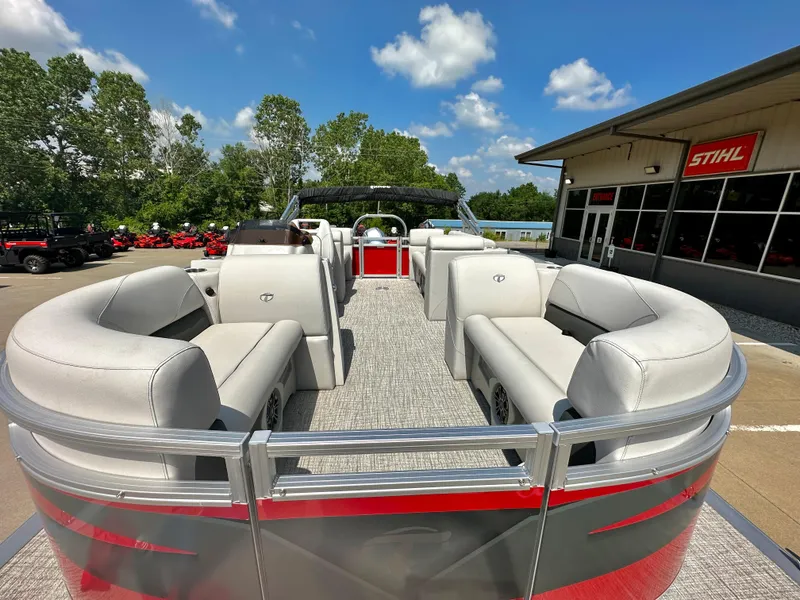 Slide: The Image of 2023 Tahoe Pontoon SLT Quad Lounge boat at dealership, outdoor view. - 12
