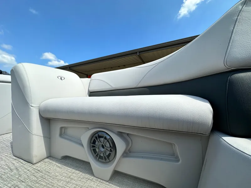 Slide: The Image of 2023 Tahoe Pontoon SLT Quad Lounge seat with built-in speaker under blue sky. - 6