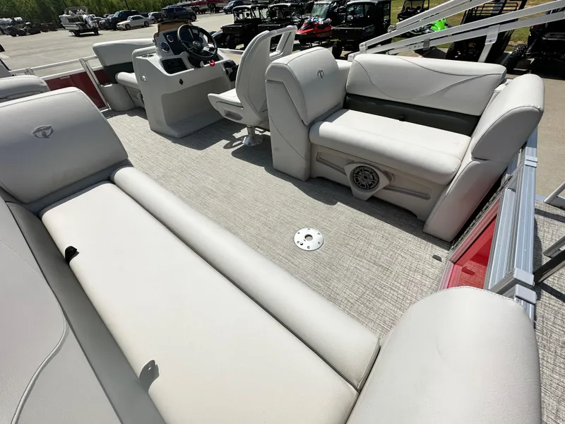 Slide: The Image of 2023 Tahoe Pontoon SLT Quad Lounge interior with plush seating and modern helm. - 9