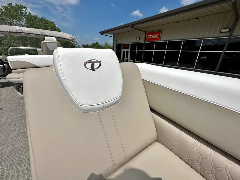 Slide: The Image of 2023 Tahoe Pontoon LTZ Rear Fish boat with beige seating, outdoor dealership. - 11