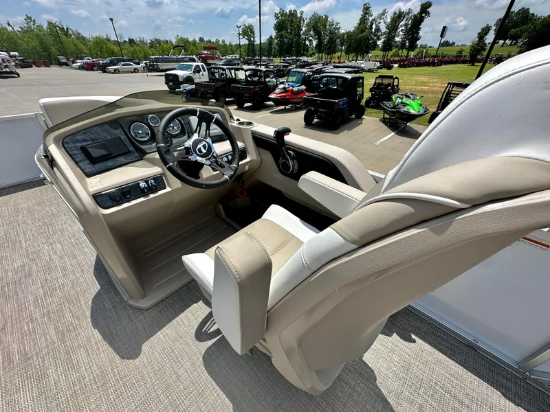 Slide: The Image of 2023 Tahoe Pontoon LTZ Rear Fish boat interior with steering console and captain's chair. - 12