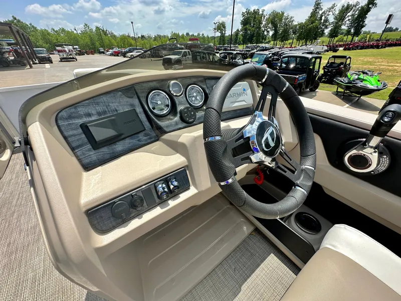 Slide: The Image of 2023 Tahoe Pontoon LTZ Rear Fish boat dashboard with steering wheel and control panel. - 13