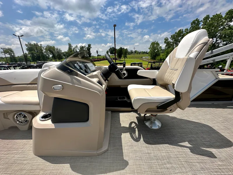 Slide: The Image of 2023 Tahoe Pontoon LTZ Rear Fish boat interior with captain's chair and control console. - 15