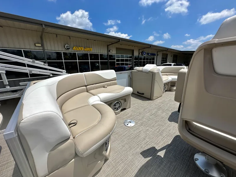 Slide: The Image of 2023 Tahoe Pontoon LTZ Rear Fish boat with beige seating, displayed outdoors. - 16