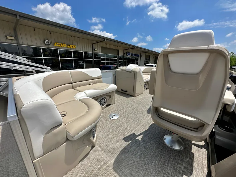 Slide: The Image of 2023 Tahoe Pontoon LTZ Rear Fish boat interior with beige seating and carpet. - 17
