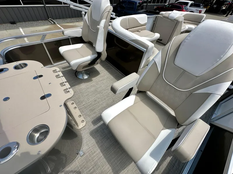 Slide: The Image of 2023 Tahoe Pontoon LTZ Rear Fish boat interior with beige and white seating. - 19
