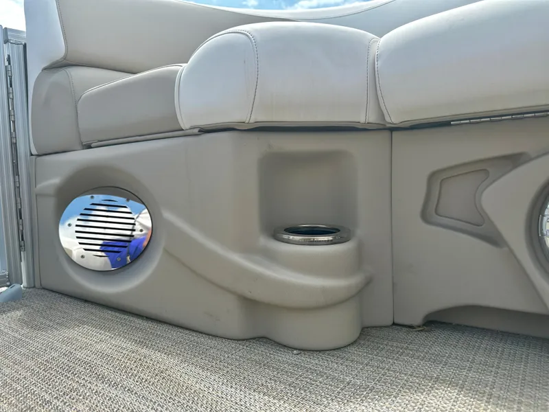 Slide: The Image of 2023 Tahoe Pontoon LTZ Rear Fish boat interior with speaker and cup holder. - 21