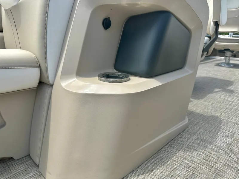 Slide: The Image of 2023 Tahoe Pontoon LTZ Rear Fish interior detail with cup holder and storage compartment. - 22