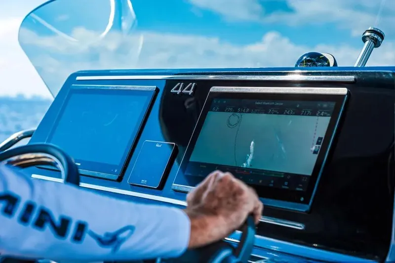 Slide: The Image of 2024 Solaris Power 44 Open yacht dashboard with navigation screens and steering wheel. - 12