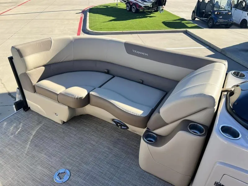 Slide: The Image of 2024 Veranda VR22VLB boat interior with beige seating and cup holders. - 12