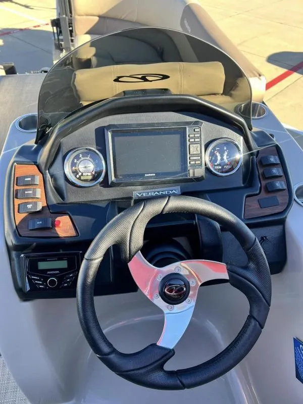 Slide: The Image of 2024 Veranda VR22VLB boat dashboard with steering wheel, gauges, and Garmin display. - 14
