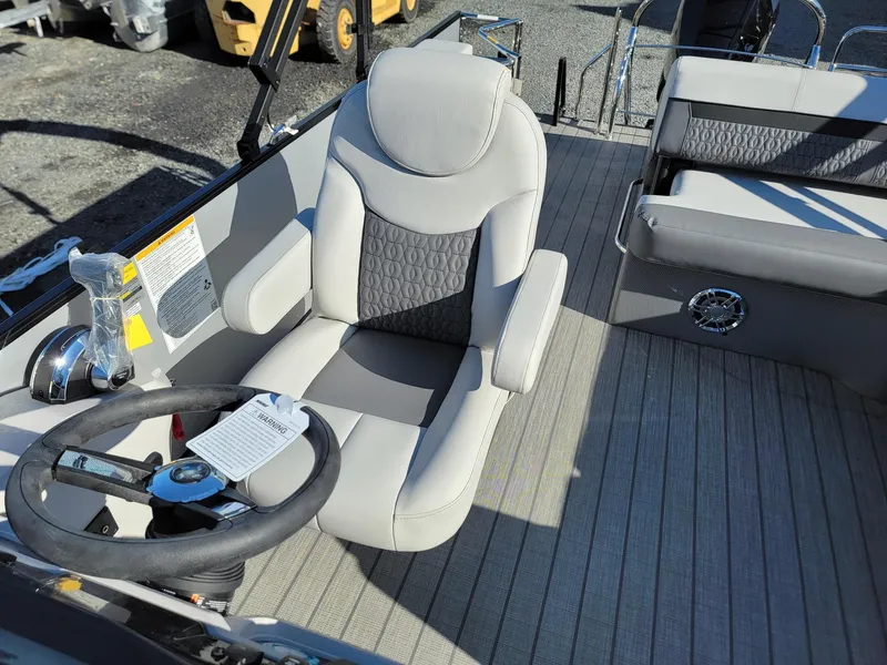 Slide: The Image of Captain's chair and helm of a 2024 Godfrey SWEETWATER 2286 SFL pontoon boat. - 12