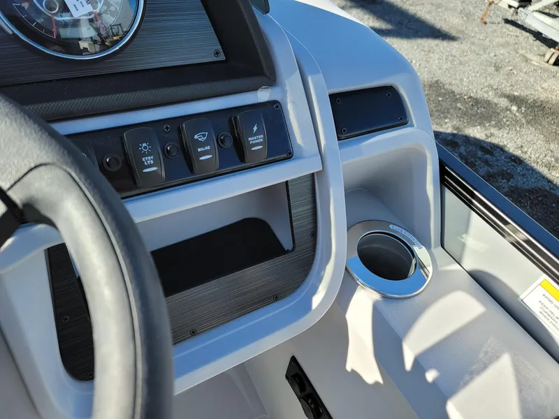 Slide: The Image of Control panel and cup holder of 2024 Godfrey SWEETWATER 2286 SFL boat. - 16