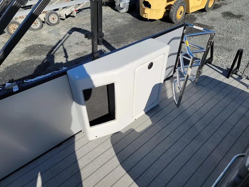 Slide: The Image of 2024 Godfrey SWEETWATER 2286 SFL boat deck with storage compartment and ladder. - 19