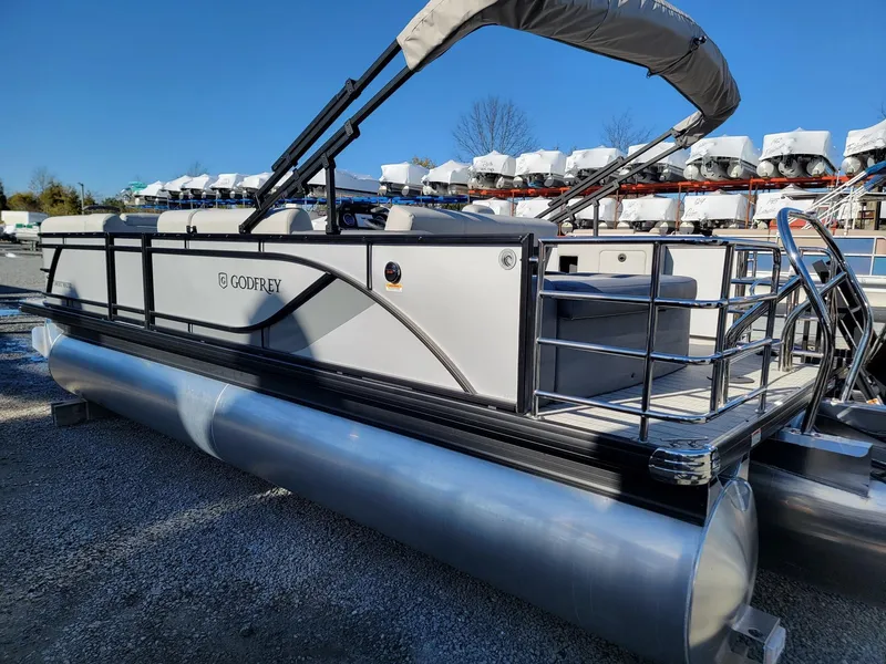 Slide: The Image of 2024 Godfrey SWEETWATER 2286 SFL pontoon boat in a storage yard. - 2