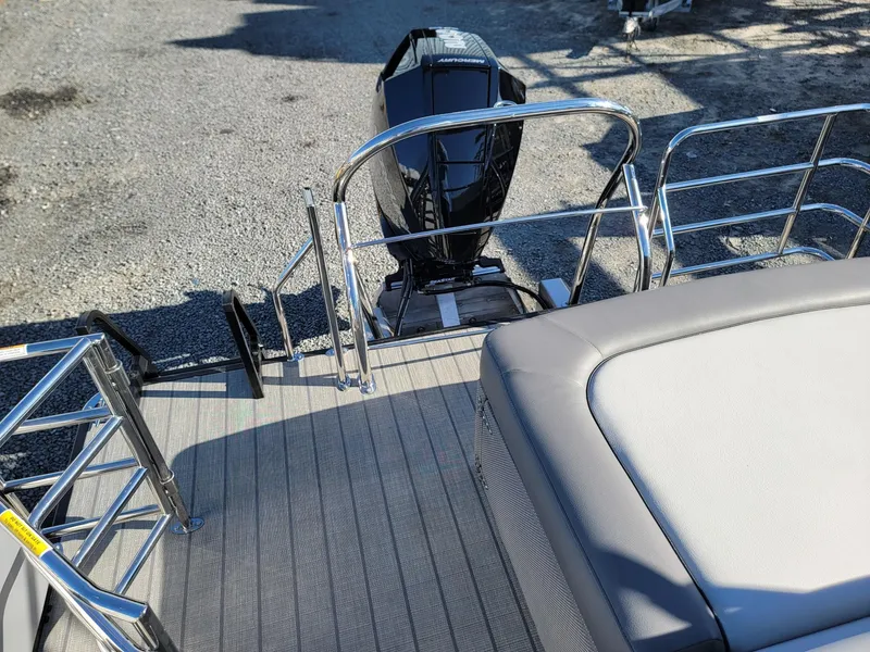 Slide: The Image of 2024 Godfrey SWEETWATER 2286 SFL boat stern with motor and seating area. - 21