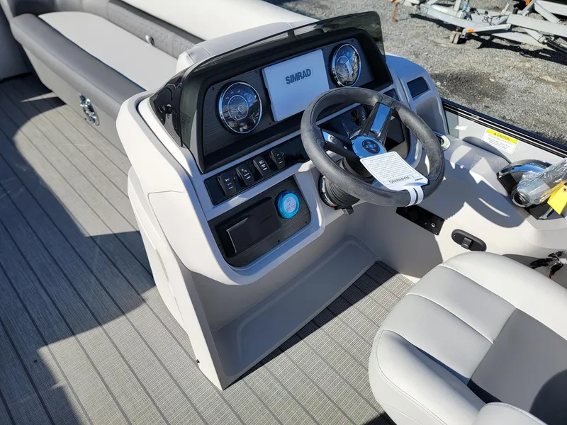 Slide: The Image of 2024 Godfrey SWEETWATER 2286 SFL boat dashboard with steering wheel and controls. - 26