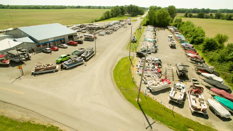 Slide: The Image of Aerial view of a boat dealership with various boats, including 2024 Qwest E-Class 820 Splash Pad LT. - 3