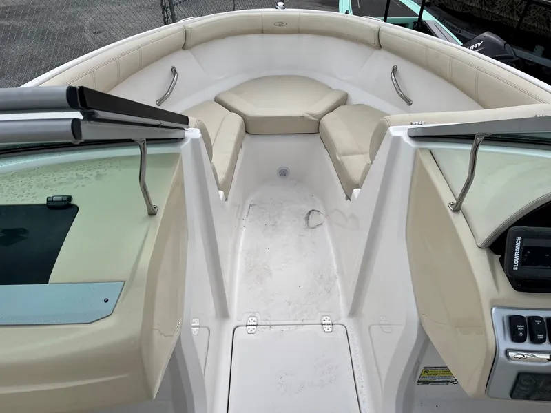 Slide: The Image of 2019 Regal 21 OBX boat interior with beige seating and white deck. - 2