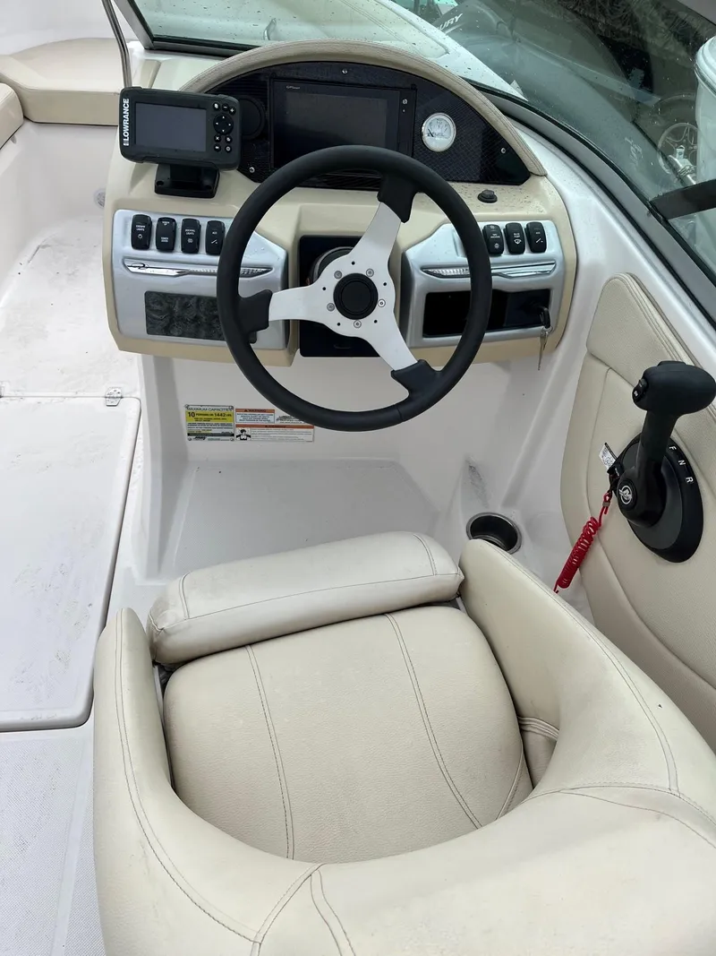 Slide: The Image of 2019 Regal 21 OBX boat cockpit with steering wheel and control panel. - 3