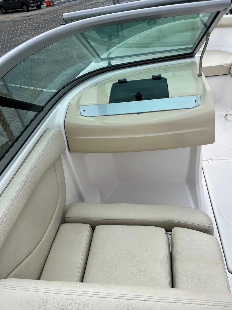 Slide: The Image of 2019 Regal 21 OBX boat interior with beige seating and windshield. - 4