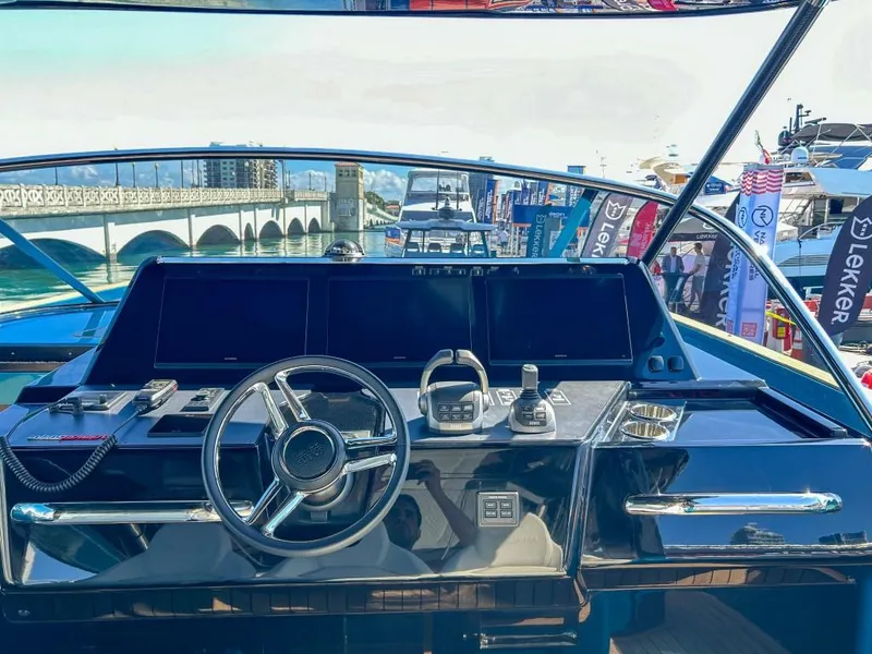 Slide: The Image of 2024 Solaris Power 52 Open yacht cruising near waterfront homes. - 12