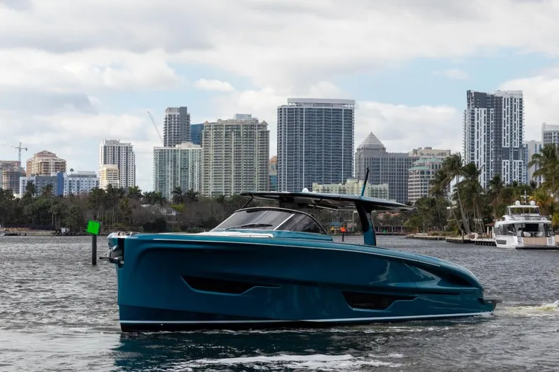 Slide: The Image of 2024 Solaris Power 52 Open yacht cruising near a coastal cityscape. - 3
